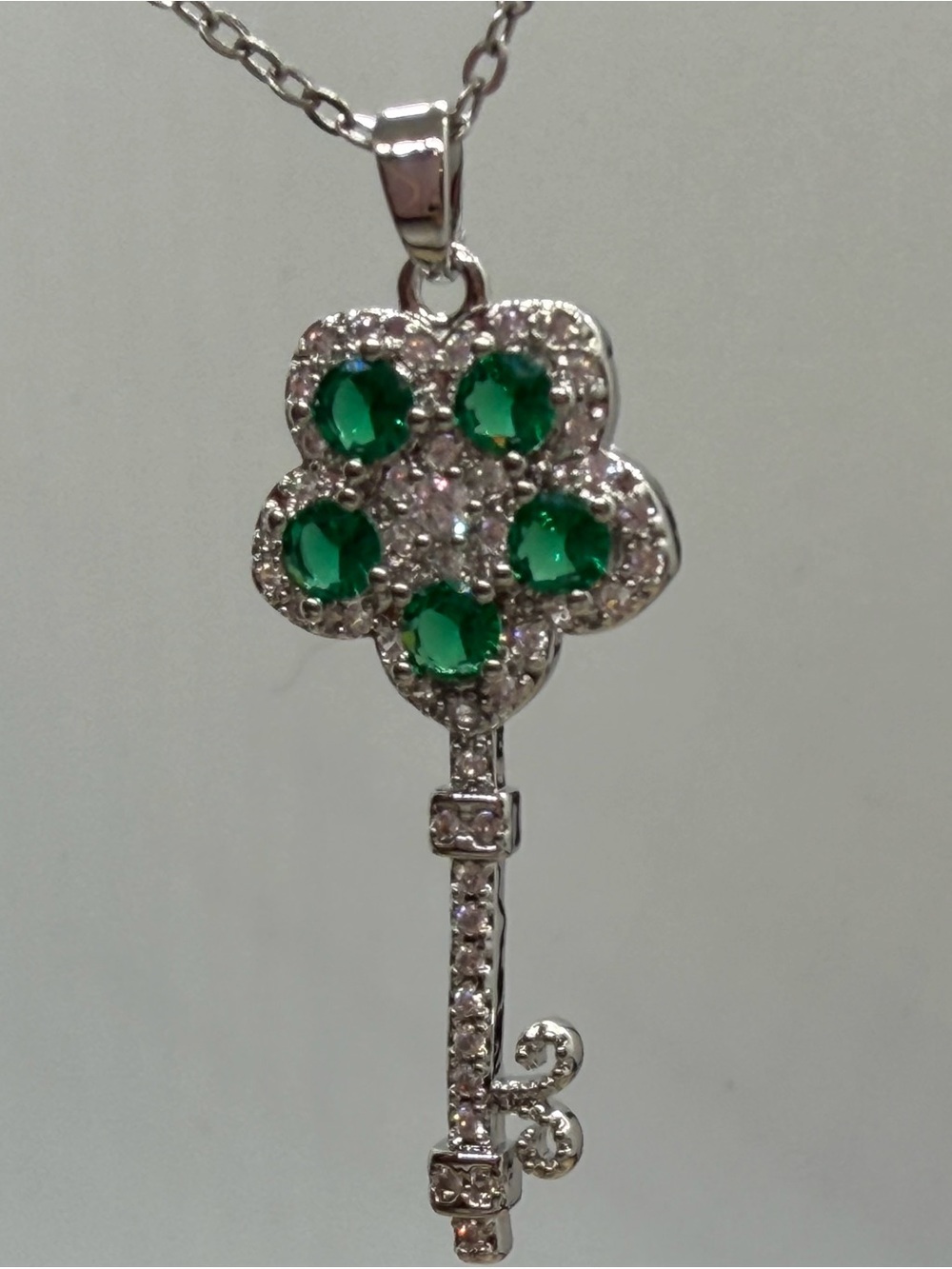 Silver Key Pendant Necklace with Green Gem Accents